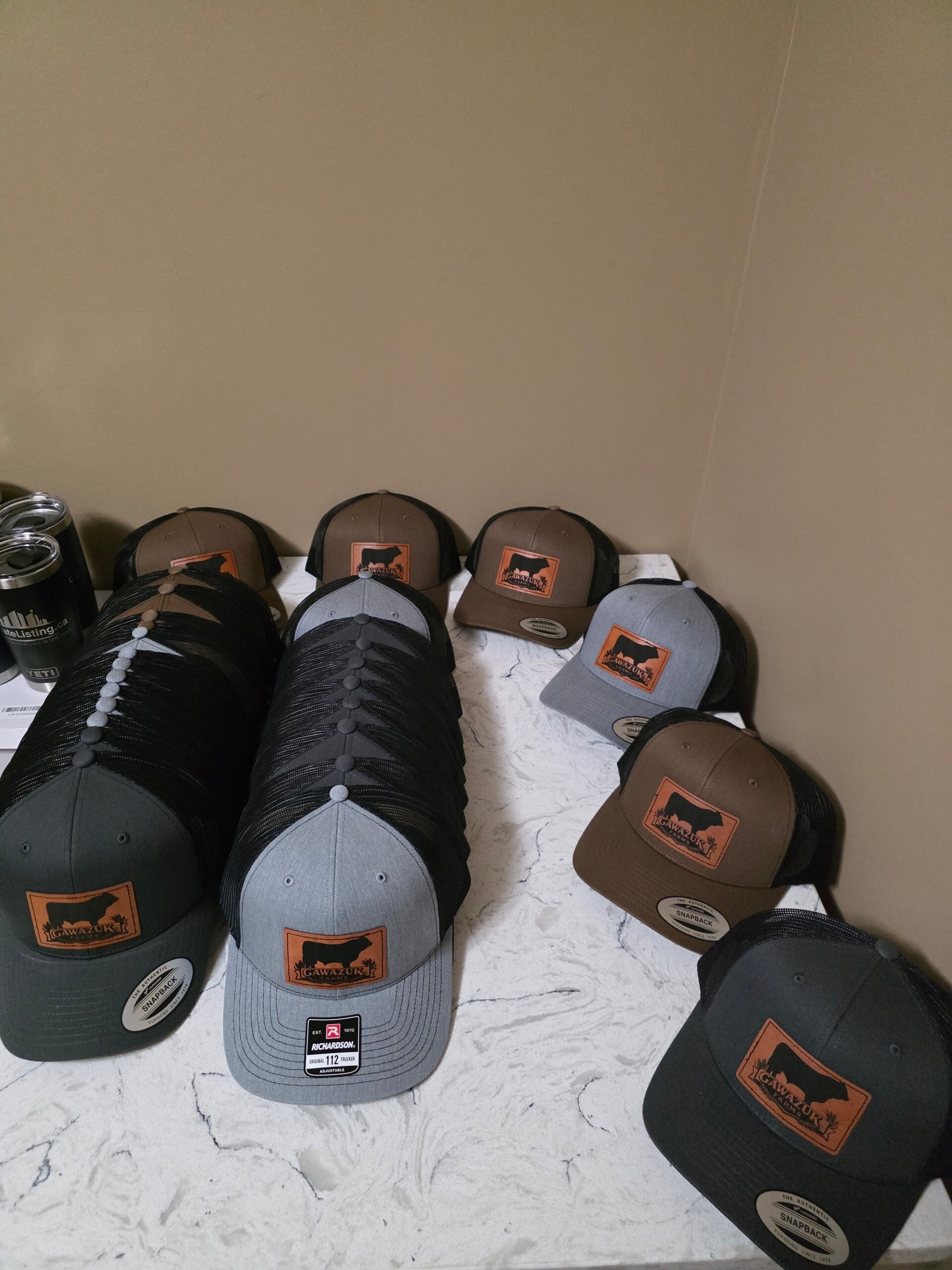 Custom laser-engraved hats and leather patches